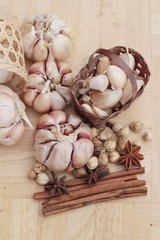 Garlic  has health benefits on wood background.