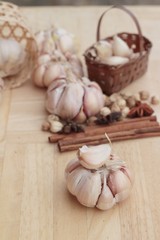 Garlic  has health benefits on wood background.