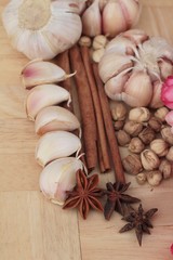 Garlic  has health benefits on wood background.