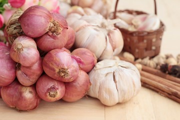 Shallot and garlic for cooking on wood background.
