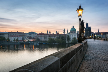 Charles Bridge at sunrise, Prague, Czech Republic. Dramatic statues and medieval towers.