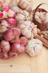 Shallot and garlic for cooking on wood background.