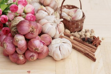Shallot and garlic for cooking on wood background.