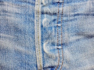 Blue denim jeans texture with fade and striped around button area