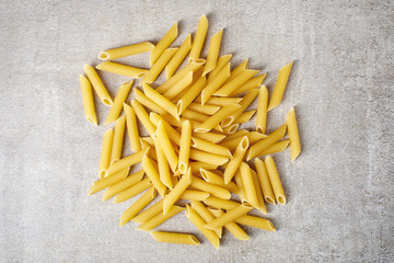 Penne pasta on stone table, from above