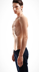 Fototapeta premium Skinny young man with anorexia on white background