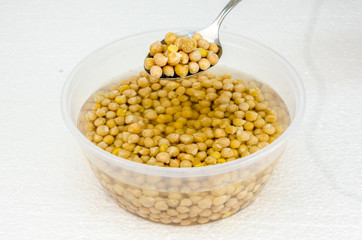 chickpeas on a white background submerged in water