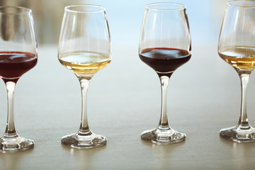 Many glasses of different wine in a row on a table