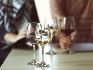 Experts tasting new sorts of wine at the table