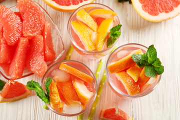 Ripe grapefruits and fresh juice with mint, close up