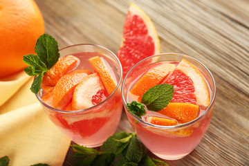 Ripe grapefruits and fresh juice with mint, close up