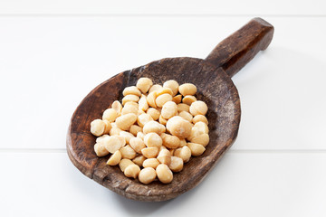 Geschälte Macadamia Nüsse auf Holzlöffel