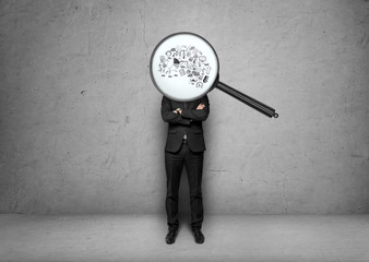 Businessman stands with magnifier instead of head