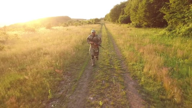 Aerial view: Military with automaton running in the forest