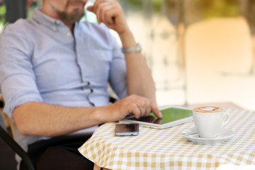 Businessman using tablet in cafe