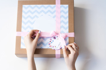Woman's hands opening present box