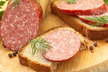 Smoked sausage with spices and greens for sandwiches