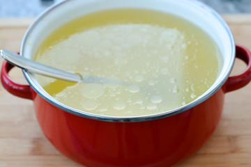 Homemade chicken stock or broth in a pot