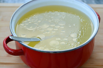 Homemade chicken stock or broth in a pot