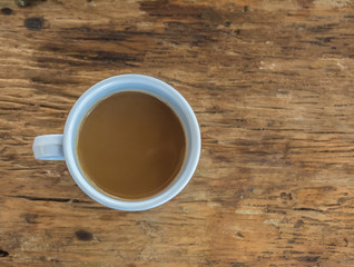 Cup of coffee on wooden table in top view