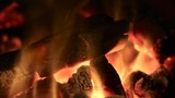 Loop-able close-up of burning logs in a fireplace