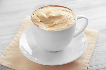 Cup of fresh coffee on napkin