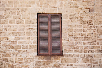 Wooden window on brick wall