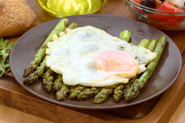 fried egg on green asparagus