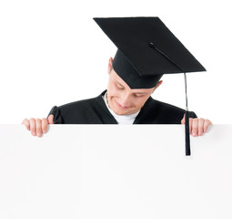 Graduate student in mantle showing blank placard board, isolated on white background