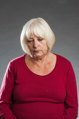 Sad, depressed - female senior portrait series on grey backgroun