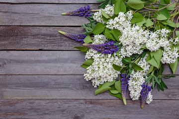 White lilac branch on a wooden background