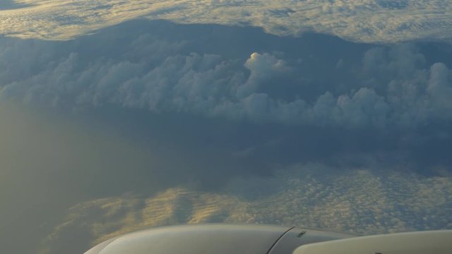 traveling by air. View through airplane window. Flight abobe spectacluar clouds. 4k