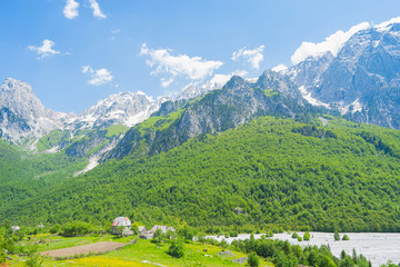 Small village with Albanian Alps on background In Valbona Valley