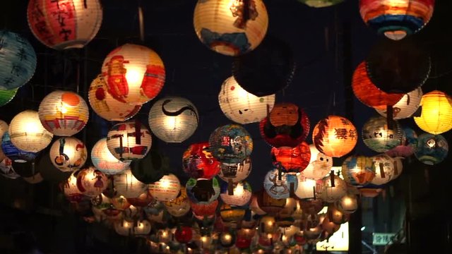 Taiwanese lantern festival. Children hand painted lanterns hanging over night walking street