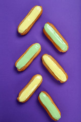 Eclairs with glaze on a paper background