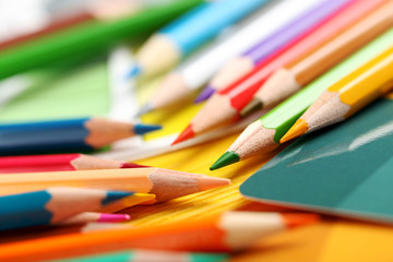 Drawing colourful pencils on a wooden background