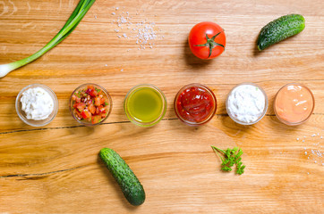 Different sauce on a wooden surface
