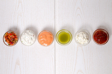 Different sauce on a wooden surface