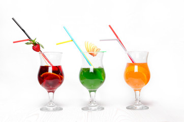 Cocktails on a white background. Various cocktails on a wooden table