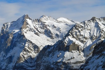 Fototapeta na wymiar Mountain peaks covered with snow lit by the sun. Jungfrau region, Switzerland, near Grindelwald.
