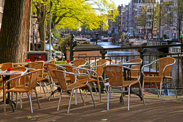 Fototapeta na wymiar sidewalk cafe on bridge of canal in Amsterdam
