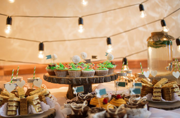 Selection of decorative desserts on a buffet table at a catered luxury event or celebration