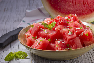 Bowl with Chunks of Watermelon and Wedge of Watermelon in the Background © rob_stathem