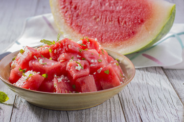 Bowl with Chunks of Watermelon and Wedge of Watermelon in the Background