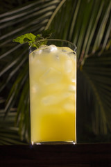 Pineapple Basil Cocktail with Palm Trees in the Background