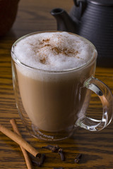 Chai Latte with Spices and Teapot on Background