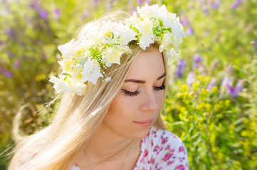 Fototapeta premium Young female with blond hair and flower coronet