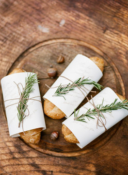 Bread rolls wrapped in napkins at place setting