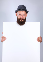 Portrait of young man in hat standing near blank, isolated on white background