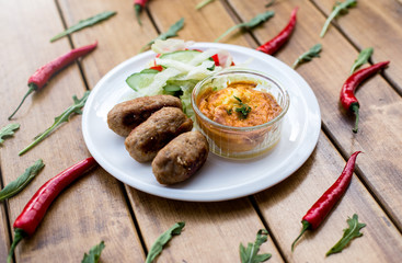 Patties with healthy salad on a white plate